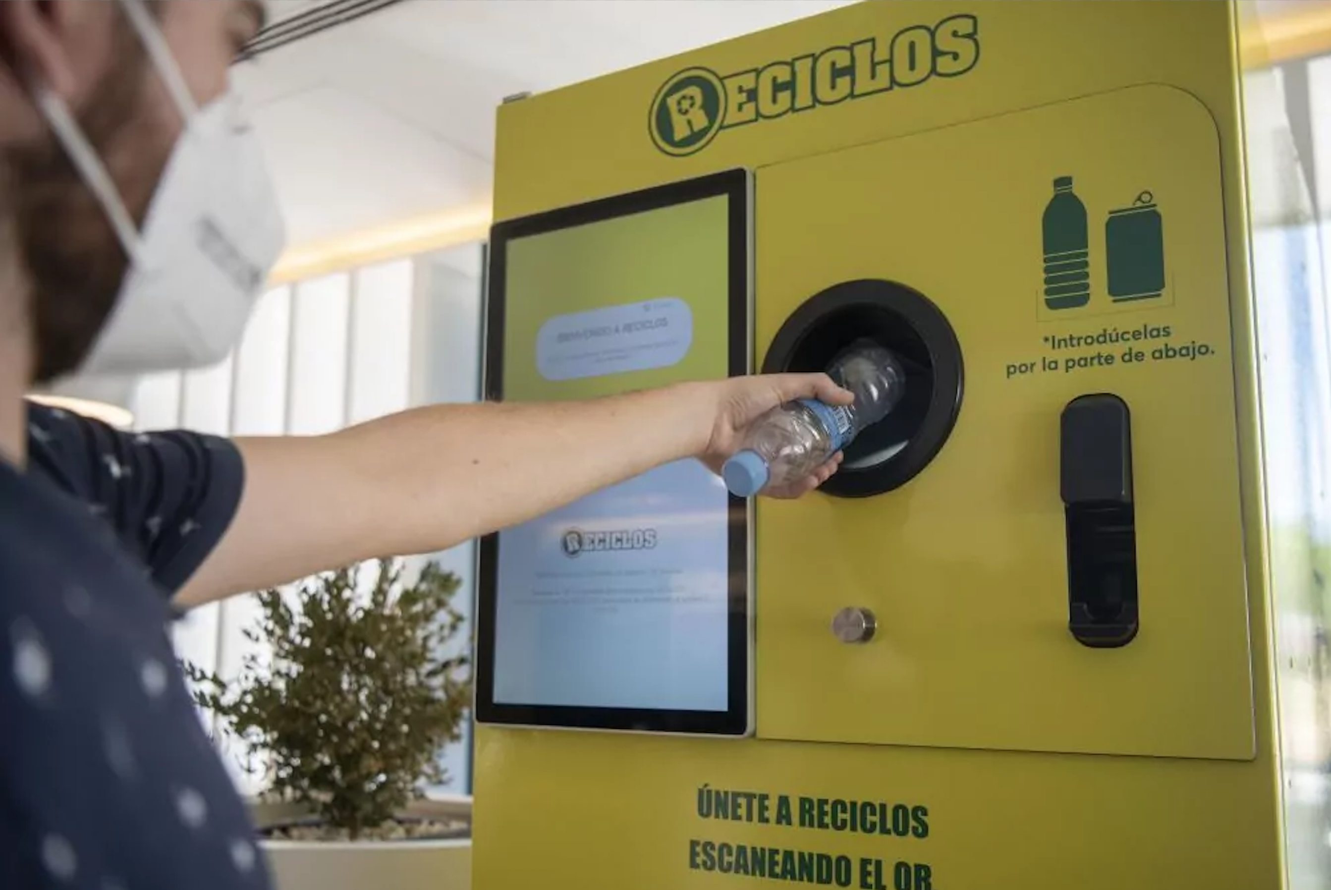 Una persona utilizando la máquina RECICLOS. / Grupo Número 1 