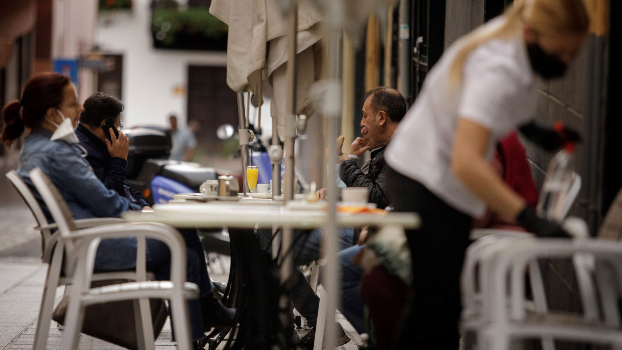 Terraza en Santa Cruz de Tenerife, Canarias, con una trabajadora limpiando una mesa. / EFE Terraza en Santa Cruz de Tenerife, Canarias, con una trabajadora limpiando una mesa. / EFE