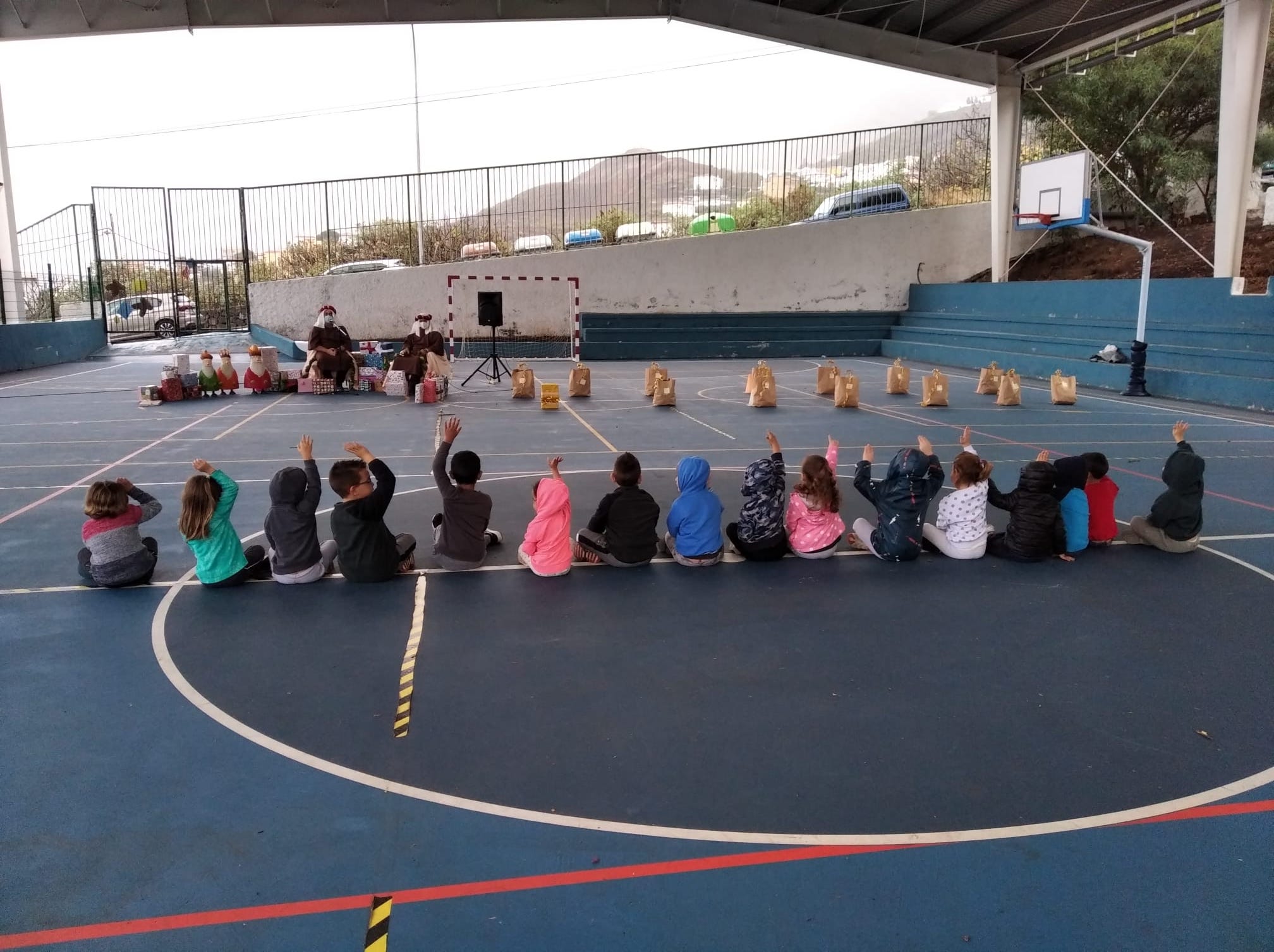 Unos niños sentados en la pista techada del colegio público Tigaday, en El Hierro./ Gobierno de Canarias