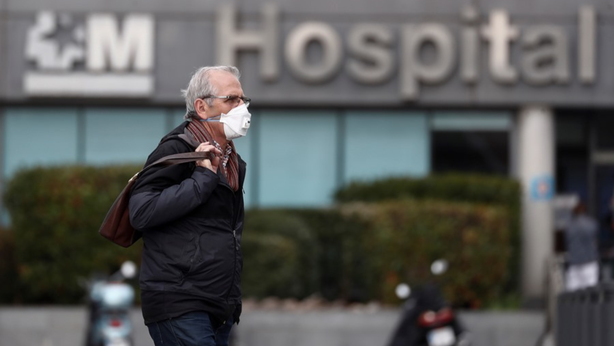 Un hombre con una mascarilla fuera de un hospital / EFE
