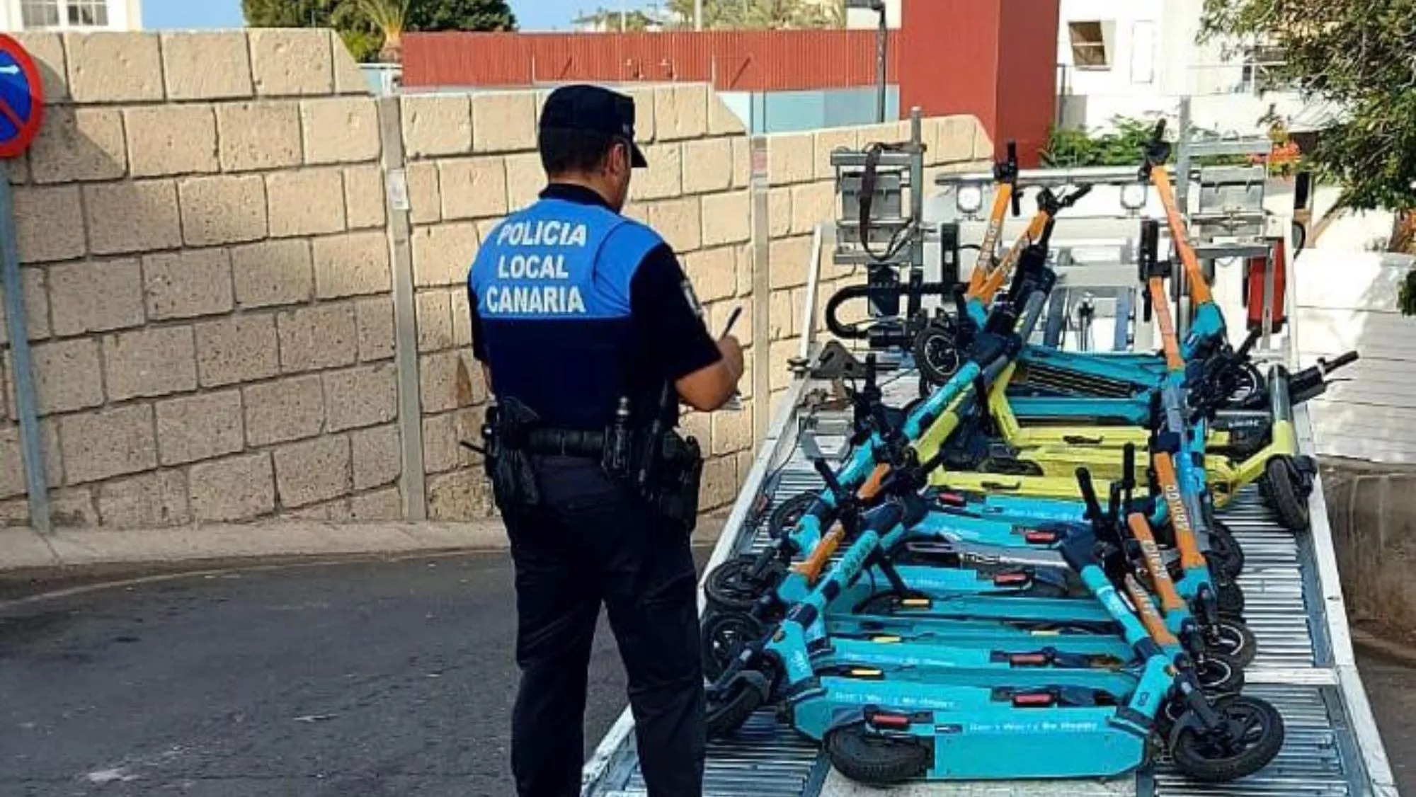 Un policía local de Arona supervisa la retirada de patinetes eléctricos / AYUNTAMIENTO DE ARONA