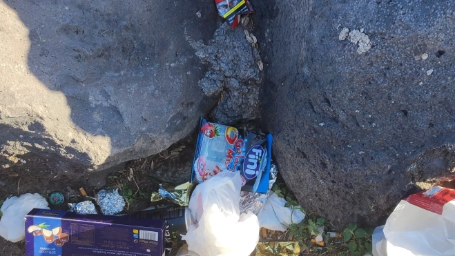 Restos de basura entre rocas 
