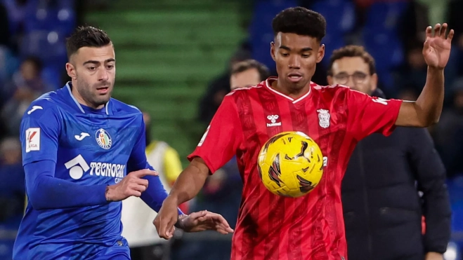  El centrocampista de Las Palmas, Marvin Olawale, intenta controlar el balón ante el defensa del Getafe, Diego Rico / EFE - SERGIO PÉREZ