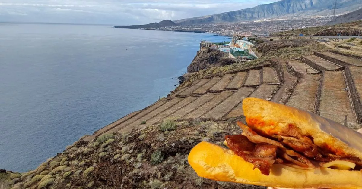 Fotomontaje del famoso bocadillo de cochino sobre las vistas que pueden apreciarse desde la esplanada donde se ubica el 'food truck' conocido como "La Borrachita de Barranco Hondo./ AH.