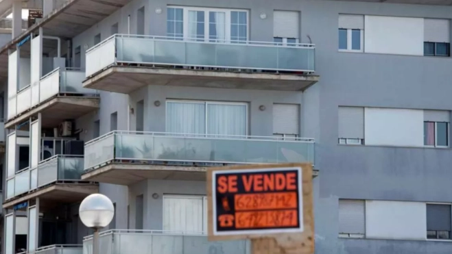 Unas viviendas con un cartel de venta / EFE Unas viviendas con un cartel de venta / EFE