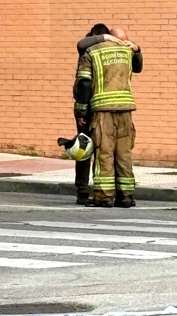Dos bomberos que intervinieron en el incendio de un coche eléctrico en Alcorcón. / REDES
