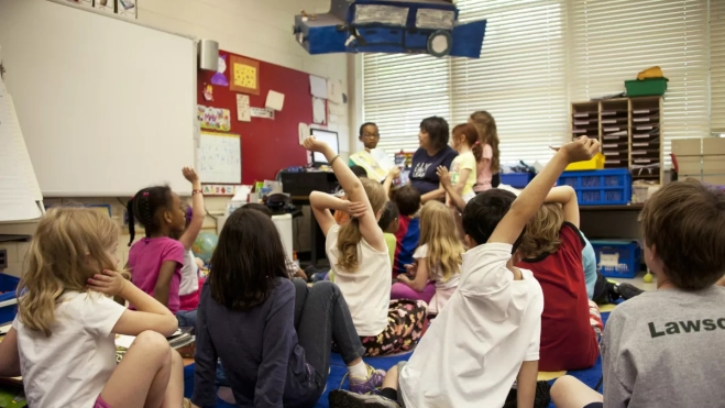 Imagen de niños en un colegio con una docente / UNSPLASH 