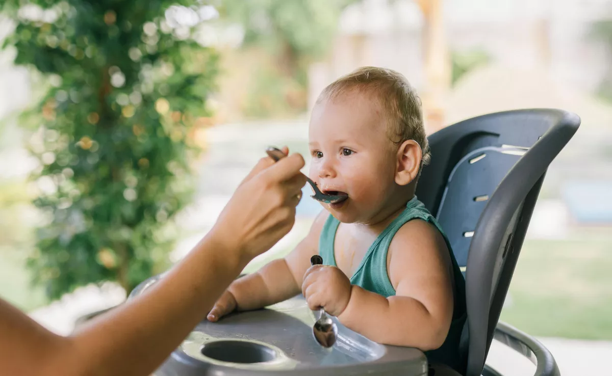 Imagen genérica de una madre dando la merienda a un bebé / PEXELS
