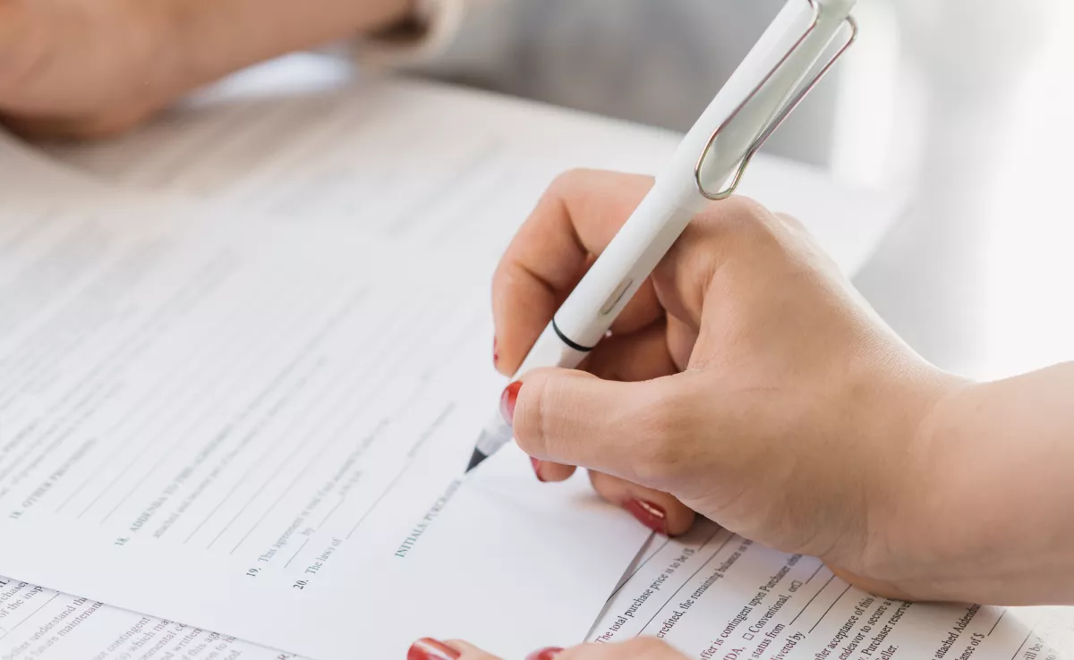 Una persona firmando un contrato de compraventa de vivienda. / CANVA