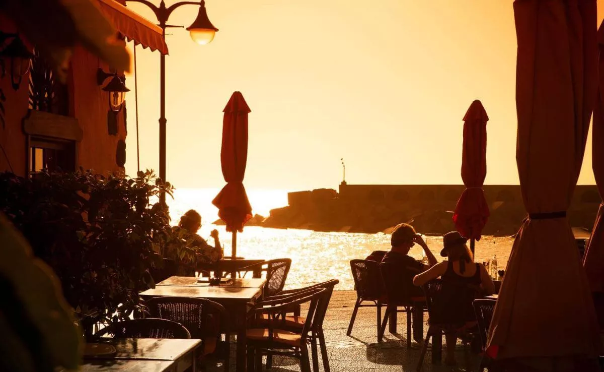 Imagen de unas personas disfrutando del sol en el pueblo de Tazacorte / TURISMO LA PALMA