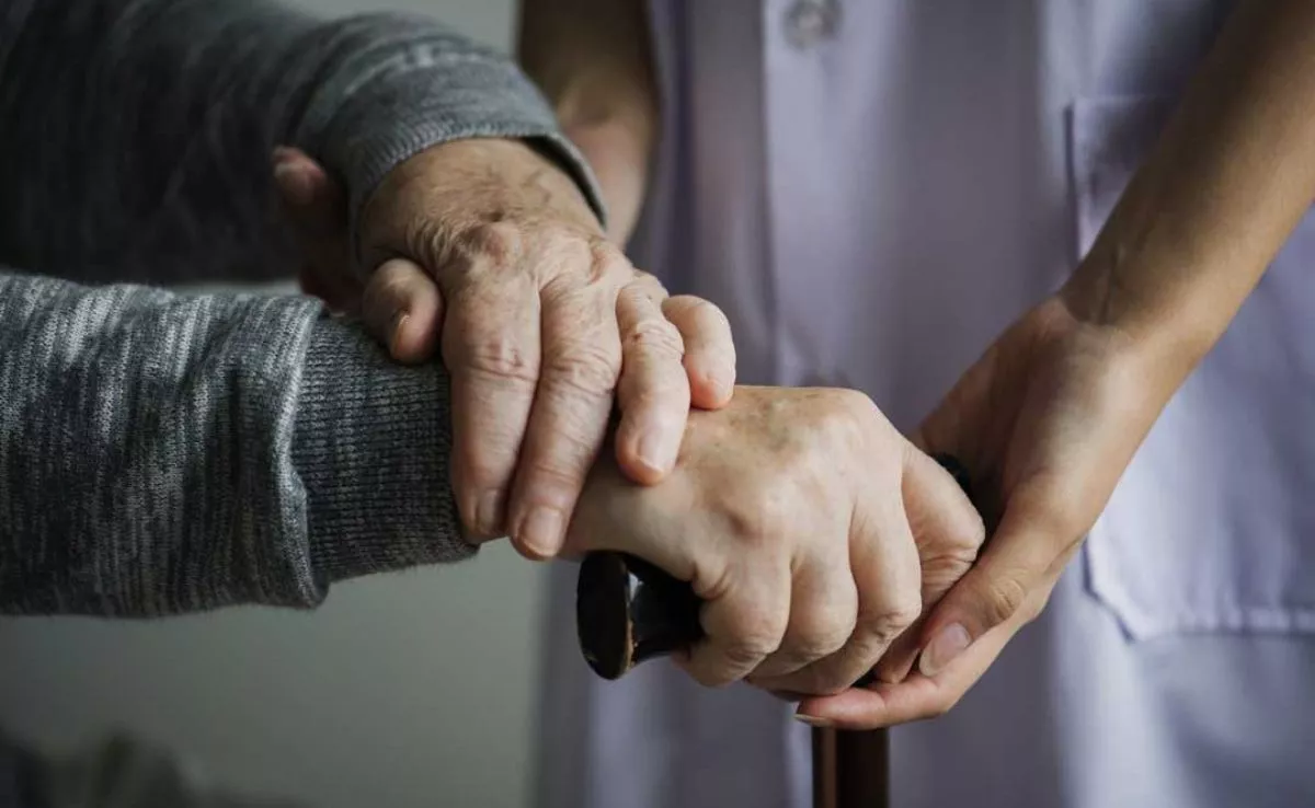 Una persona mayor siendo atendida por personal sociosanitario. /Archivo