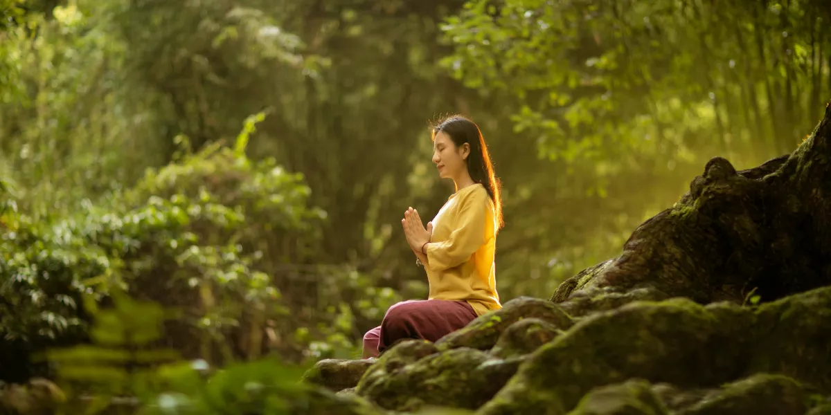 Imagen de una persona meditando en un bosque / PEXELS