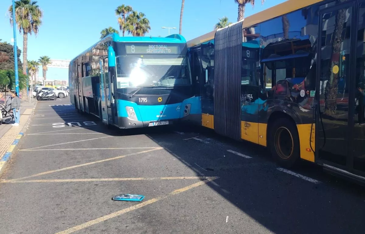 Una guagua municipal y otra de Global quedaron cruzadas en la vía tras la colisión registrada en la zona de Juan XXIII, donde se acumularon cristales y restos del impacto en el asfalto. AH