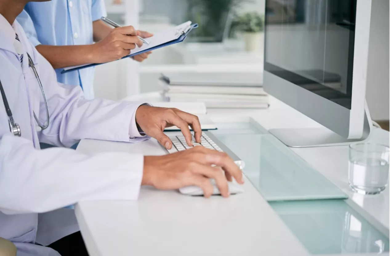 Trabajadores sanitarios frente a un ordenador de mesa
