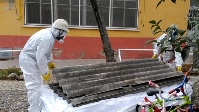 Un operario retira parte del techo protegido por la existencia de amianto en una empresa / EFE-ADRIAN RUIZ DE HIERRO