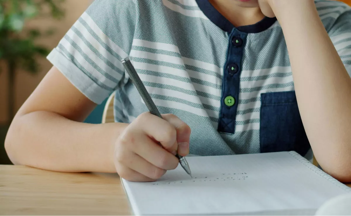 Imagen de un niño haciendo la tarea. / CANVA