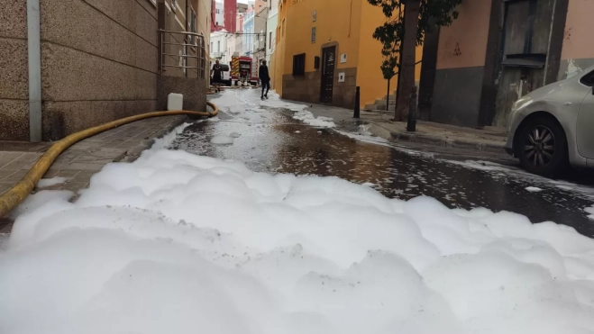 El agua y la espuma empleada para sofocar las llamas, calle abajo, por Domingo Guerra del Río. / M. REYES El agua y la espuma empleada para sofocar las llamas, calle abajo, por Domingo Guerra del Río. / M. REYES