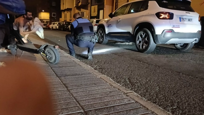 Un agente de la Policía Local trata de atrapar al cocodrilo en la calle Faro, en el barrio de La Isleta. AH
